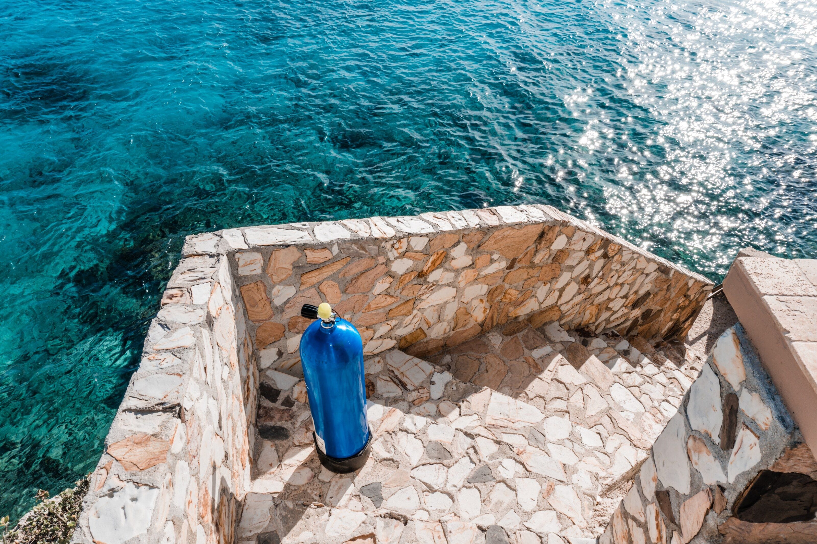 Dive tank above turquoise water